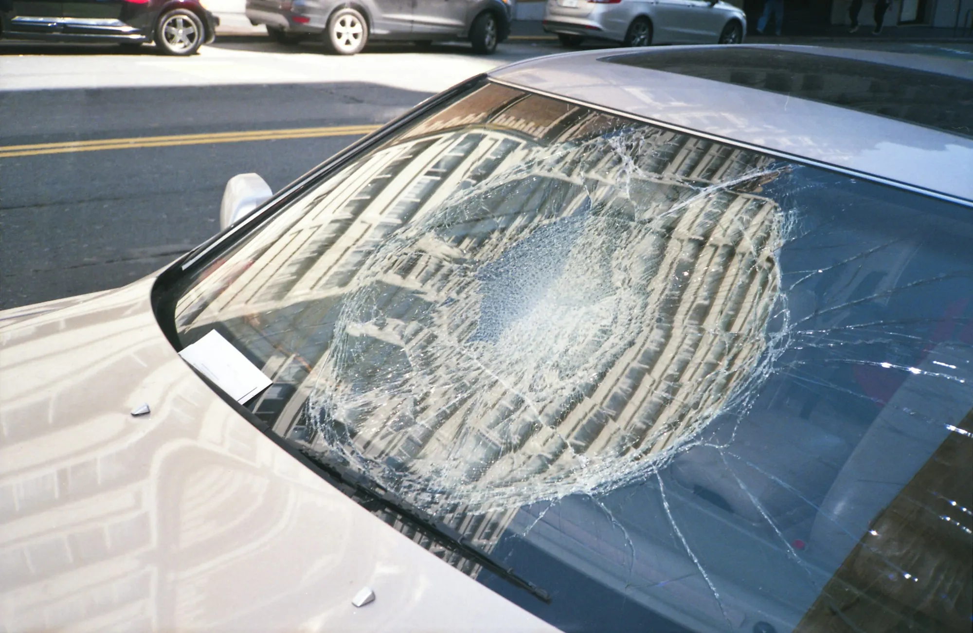 Shattered windshield on a white car